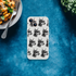 Gangster Dog iPhone case for 13-16, slim clear protective cover with repeating dog heads wearing sunglasses and chains.