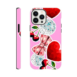 Pink iPhone case featuring a sticker-style design with cherries, heart-patterned bows, disco balls, and geometric red hearts for a bold Y2K aesthetic.