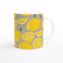 Cute Lemon Mug ceramic coffee cup with yellow lemon slices on gray background and white handle.