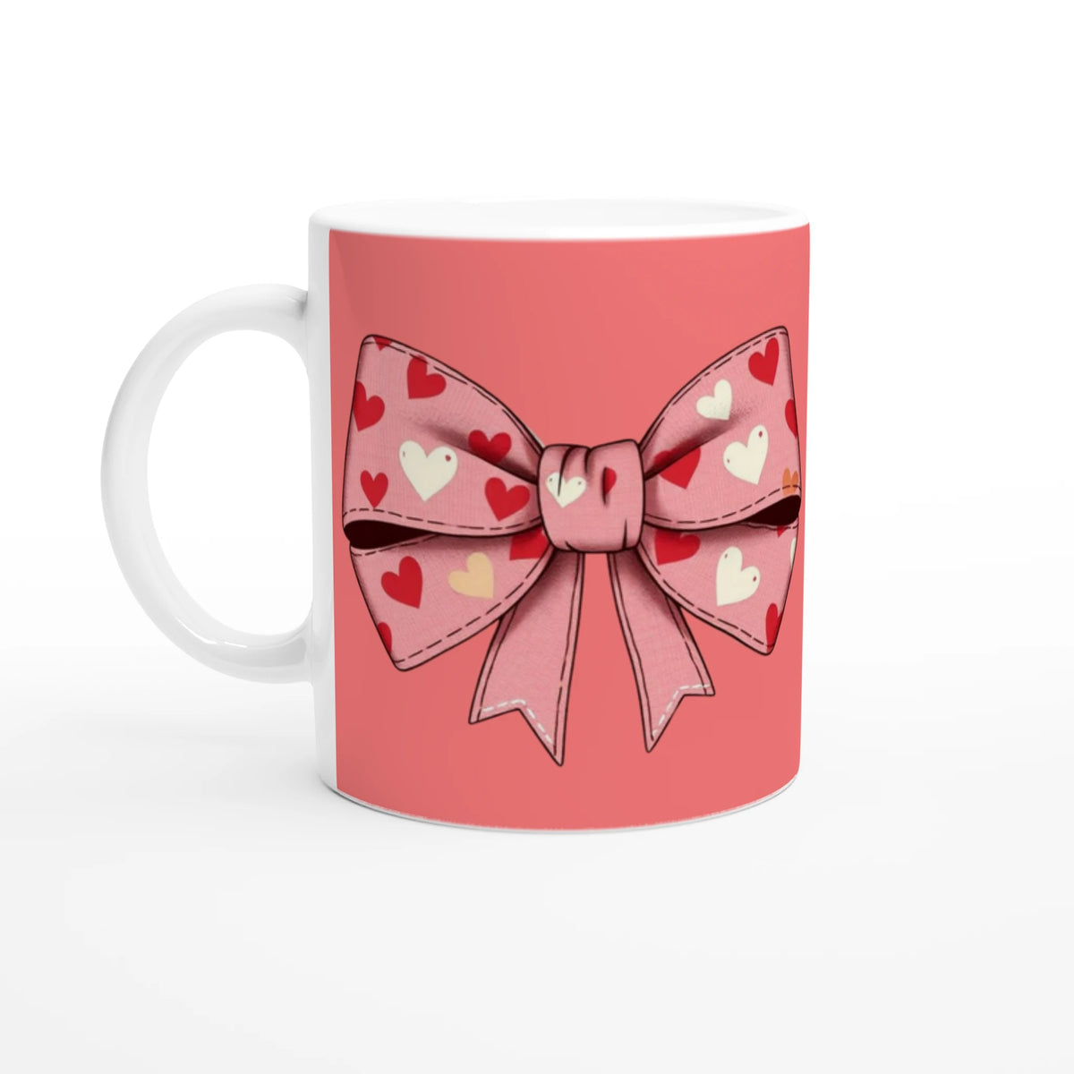 Cute pink and cream coquette bow mug with heart-pattern bow and white handle.