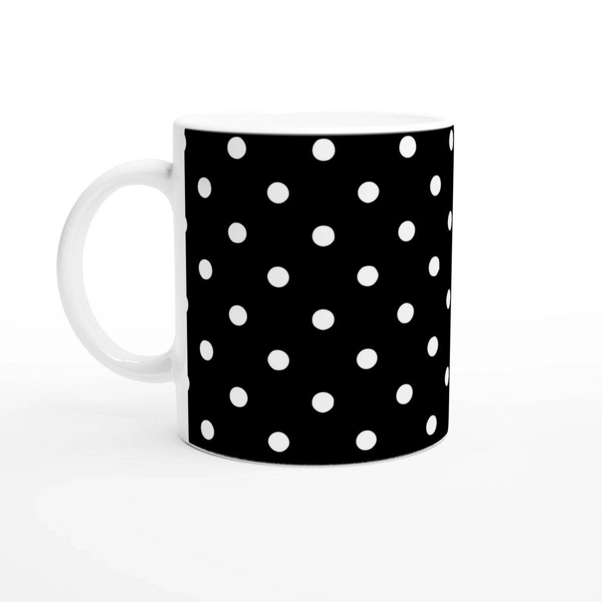 Black and white polka dot ceramic mug featuring a spotty pattern for coffee or tea.
