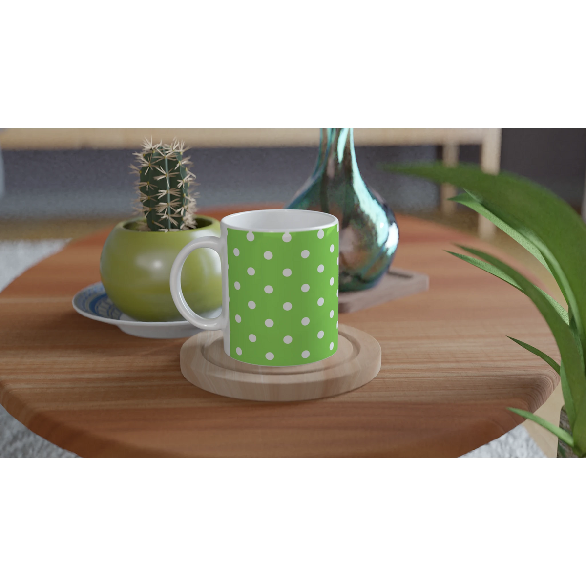 Green and white polka dot ceramic mug on a wooden coaster, featuring a vibrant spotty motif next to a small cactus.