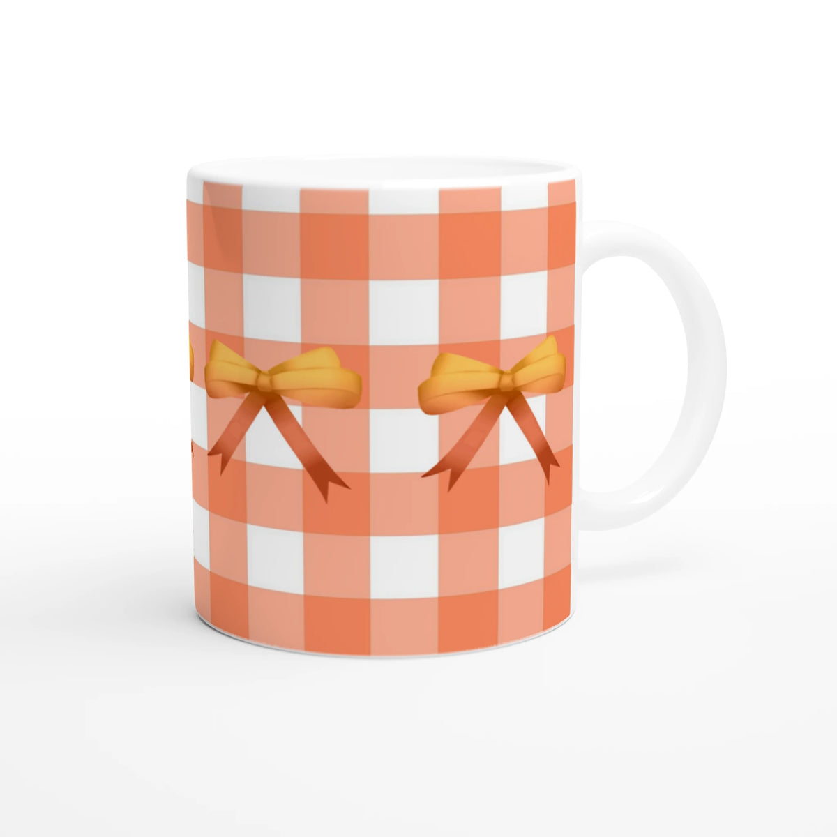 Orange gingham bow mug, a cute Coquette coffee cup with bows and a white handle.