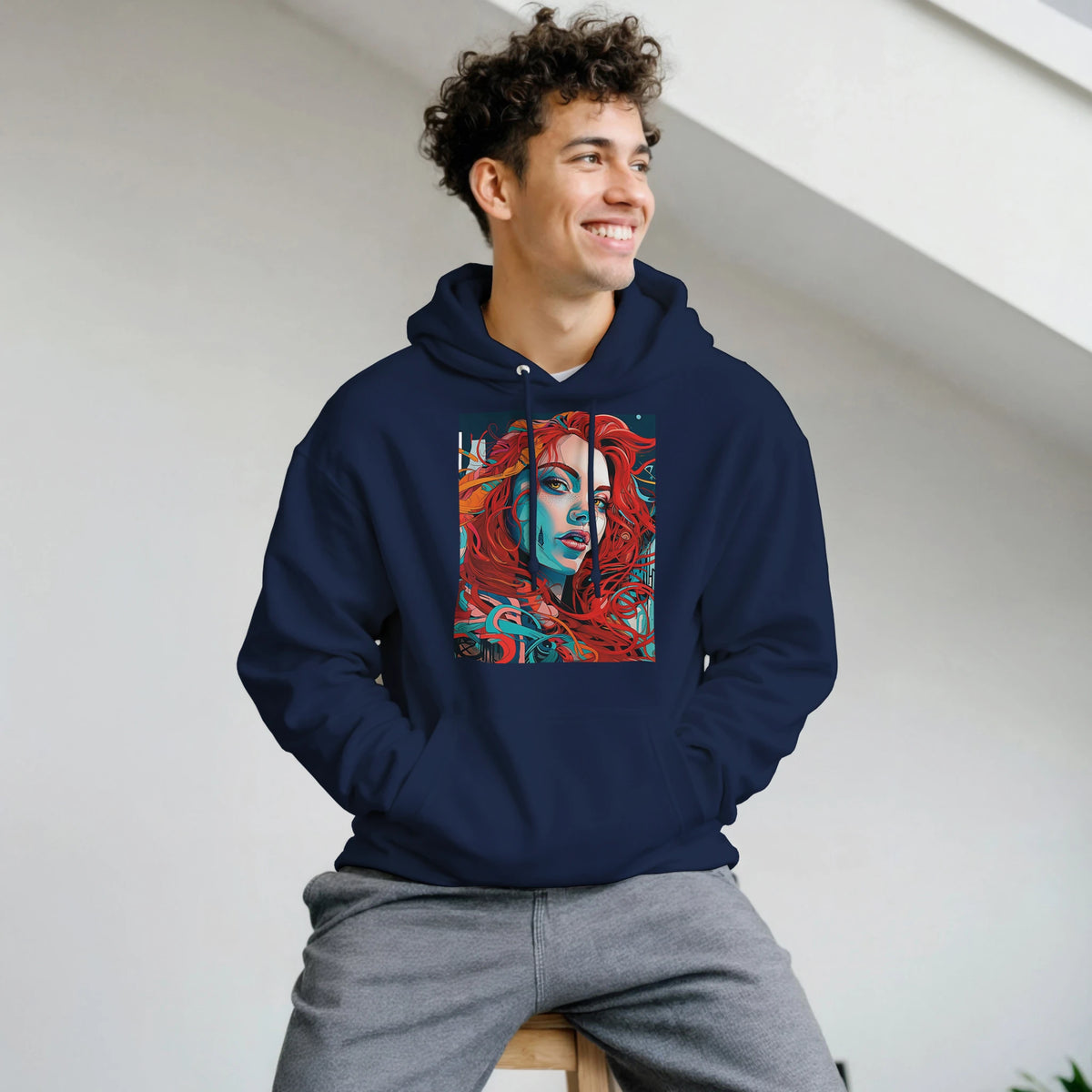 Man wearing navy blue hoodie with bold urban pop art graphic of a redheaded woman in teal and red streetwear pullover.