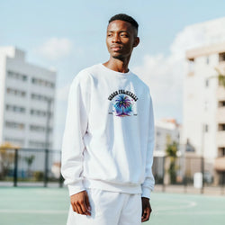 Man wearing white Urban Palm Trees sweatshirt featuring palm tree graphic, retro streetwear aesthetic.