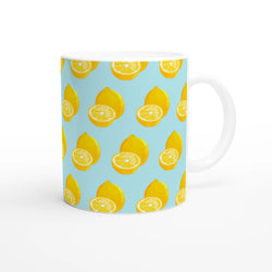 Cute pastel blue ceramic mug featuring a bright yellow whole and sliced lemon pattern for summer coffee or tea.