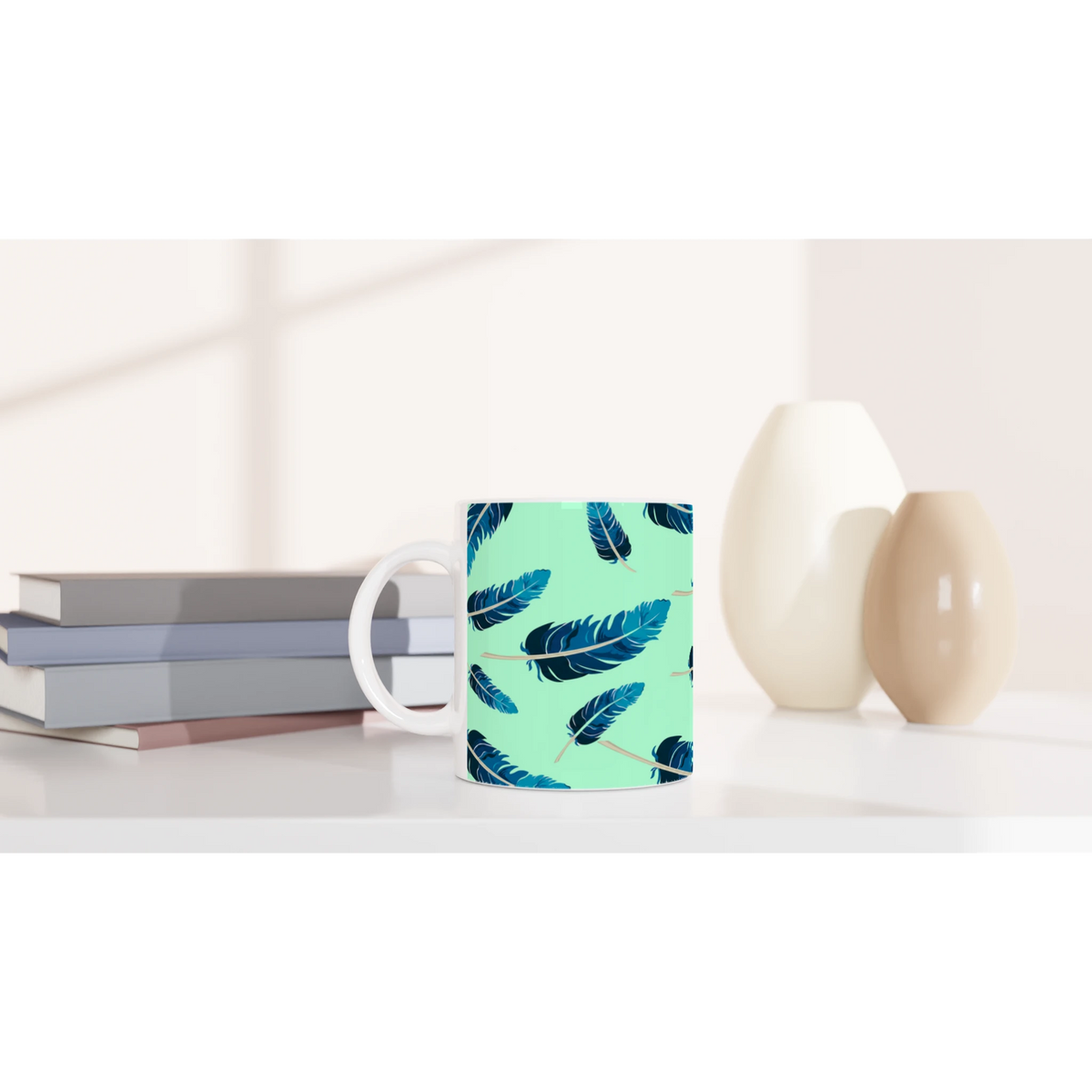 Blue Feather Mug - Mint Green Aesthetic Coffee Cup with blue feather pattern on a white desk.