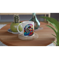 White ceramic mug featuring a colorful Flat Out graphic with palm trees and a checkered flag, set on a wooden table.