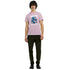 Male model wearing pink teddy bear graphic T-shirt with blue bear and "WANTED" Dead or Alive design.