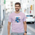 Man in pink Teddy Bear graphic T-shirt featuring a blue bear and Dead or Alive print, casual streetwear