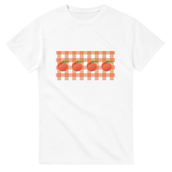 White women's tee with peaches on orange gingham background, summer fruit aesthetic.