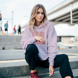Lavender oversized hoodie featuring a vintage red cherry graphic on a gingham square, styled with black cargos for a retro streetwear look.