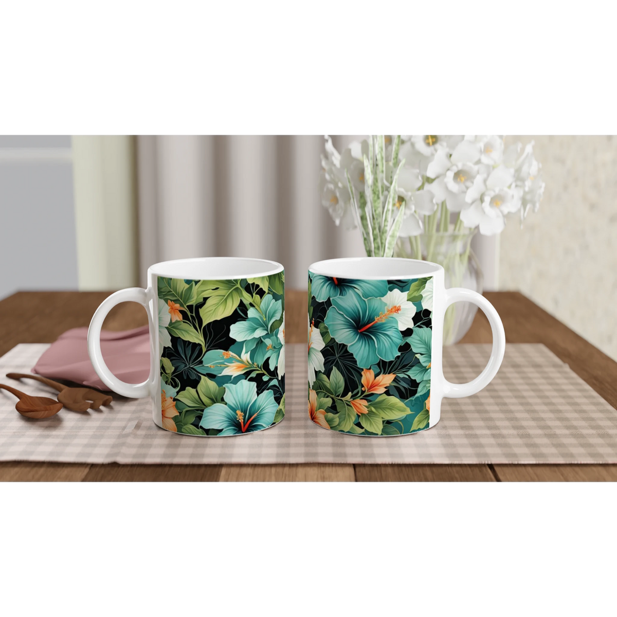 Two tropical hibiscus mugs with leaf and flower patterns on a wooden table, bouquet in the background.