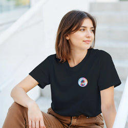 Woman wearing black crew neck t-shirt featuring colorful circular Urban Palm Trees graphic on the chest.