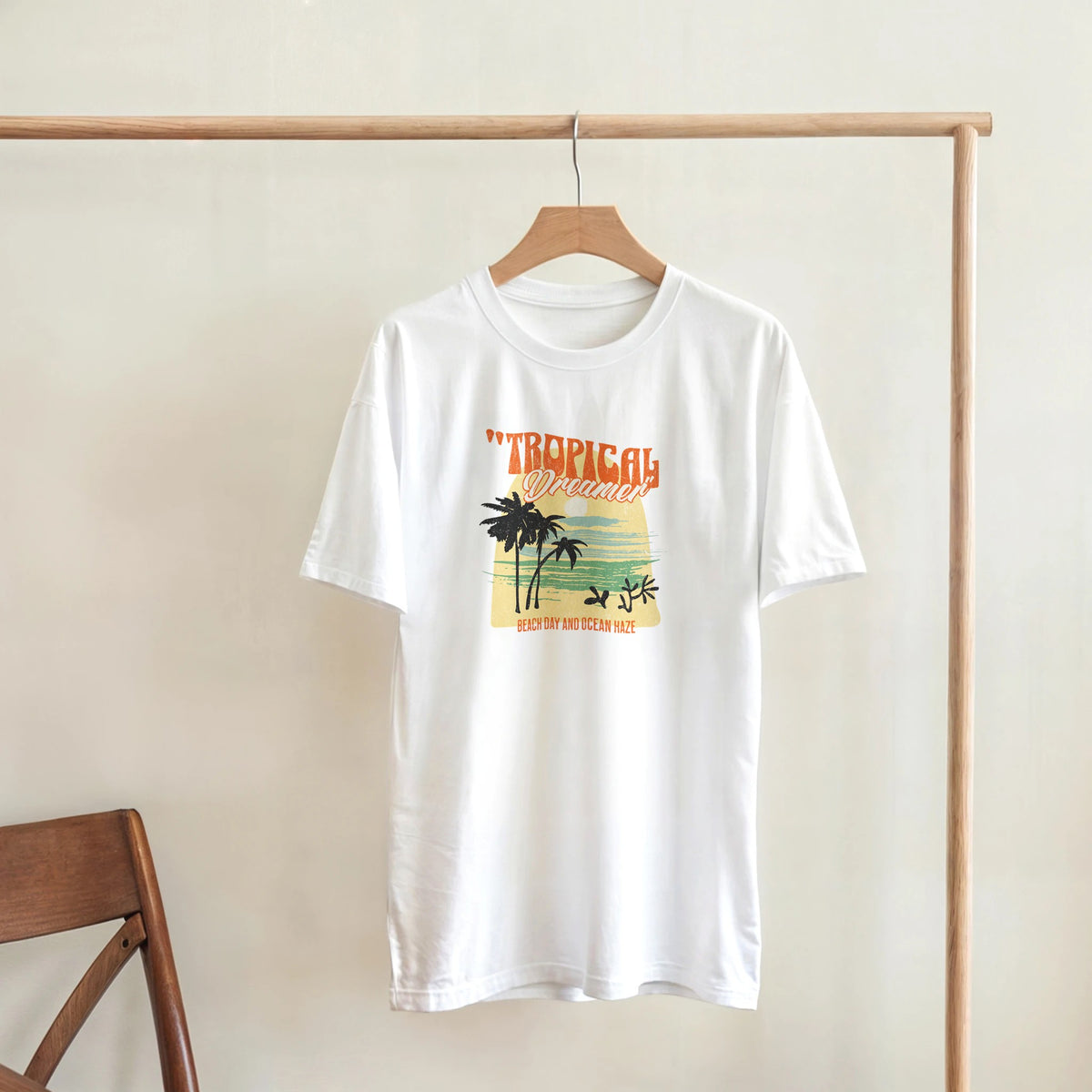 White women's short-sleeve crew-neck T-shirt with Tropical Dreamer palm-tree sunset graphic.
