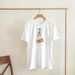 White t-shirt featuring a retro cassette tape graphic with unspooling black tape, capturing nostalgic 80s music streetwear vibes.