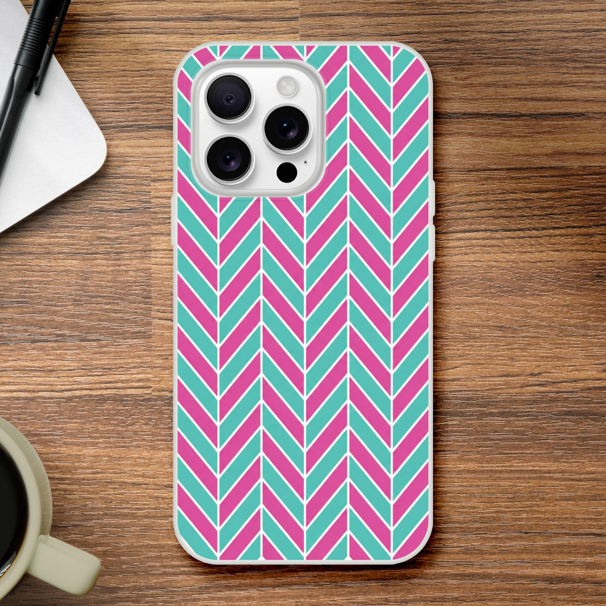 Pink and turquoise herringbone iPhone case with geometric chevron pattern. Impact-shielding TPU cover for iPhone 13-16 with matte finish.