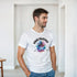 Man wearing white Urban Palmtrees T-shirt with a colorful palm tree graphic.