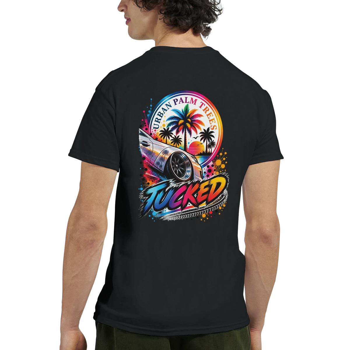 Black T-shirt back with colorful "Tucked" graphic featuring a lowered modified car, palm trees, and sunset. Modified car culture tee.