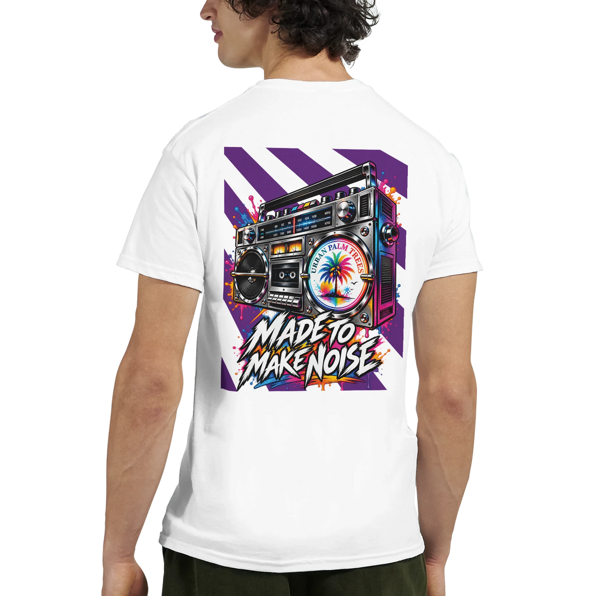 White tee featuring a vibrant retro boombox graphic on the back with purple stripes, splatter details, and "Made to Make Noise" text.
