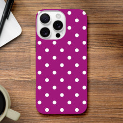 Purple and white polka dot tough iPhone case with shock-absorbing TPU protection for models 13 through 16 on a wooden surface.