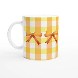 Yellow gingham bow mug with orange ribbon bow design.