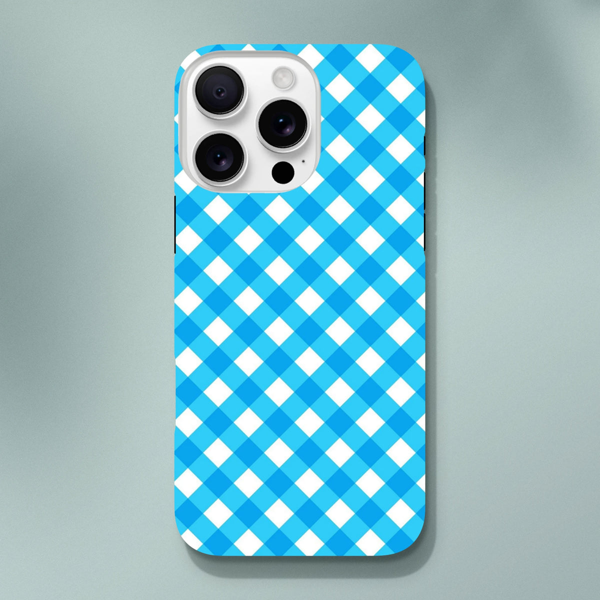 Blue gingham checkered tough iPhone case featuring a cute retro design. Shock-absorbing protection with wireless charging compatibility.