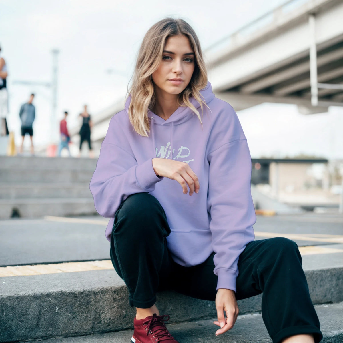 Woman wearing Cute Wild Heart Hoodie in lavender, a cozy slogan top for women, urban streetwear.