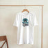 White women's cotton-blend T-shirt with circular tropical palm and sunset graphic reading Summer Beach.