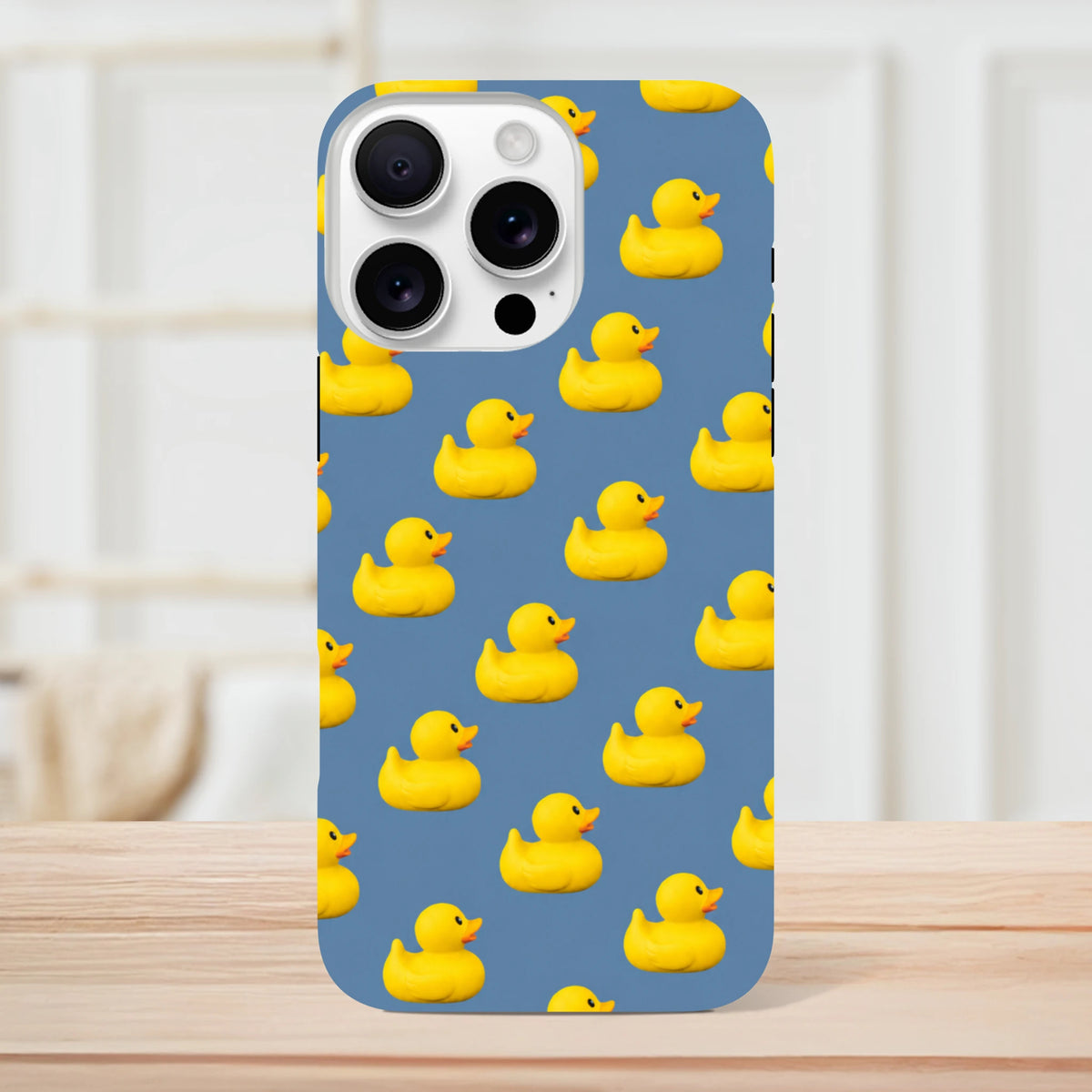 Blue iPhone case featuring a playful pattern of yellow rubber ducks for a cute kawaii streetwear look.