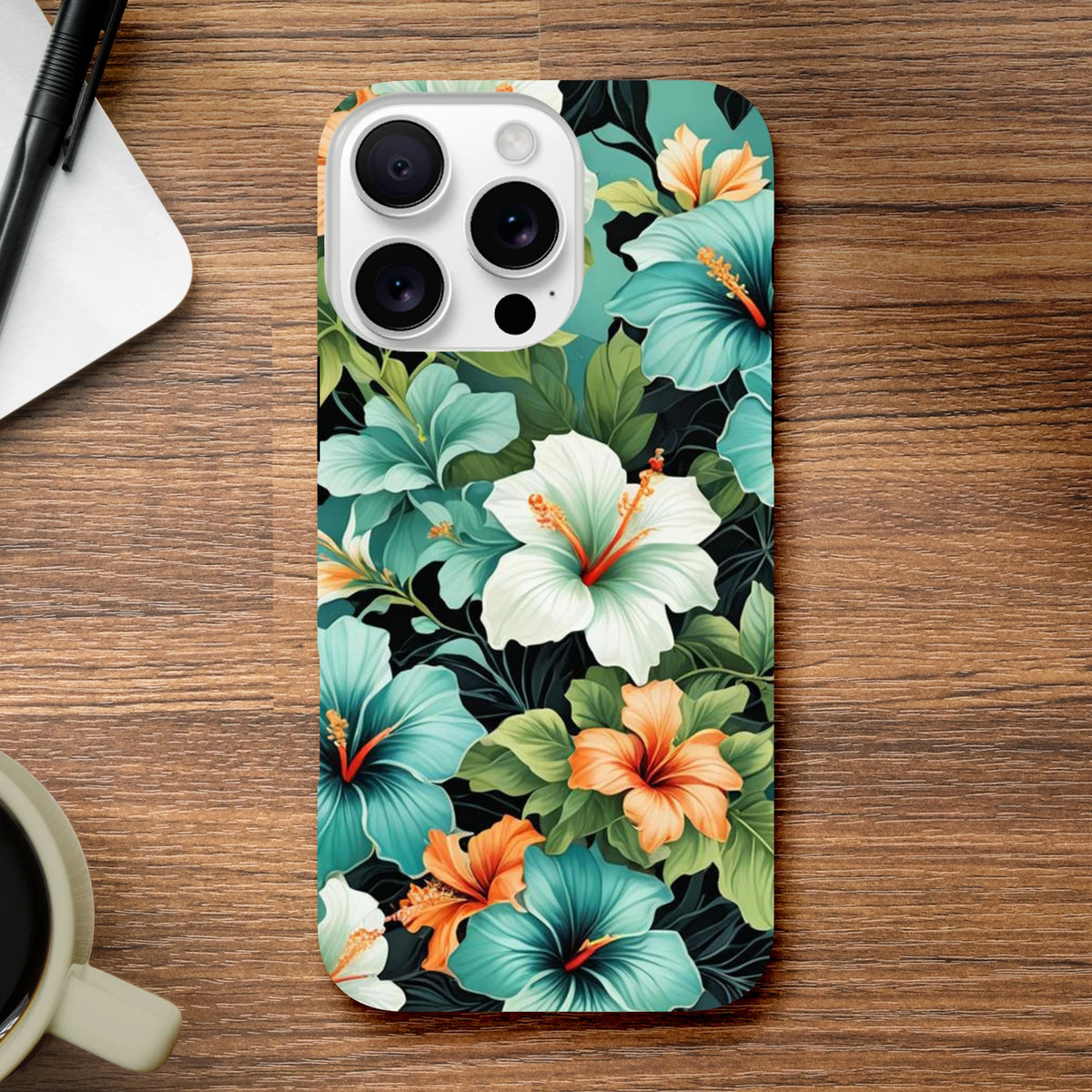 Tropical floral iPhone case featuring vibrant blue, white, and orange hibiscus flowers with lush green leaves on a dark background.