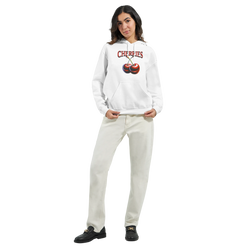 Woman modeling a white Y2K cherries hoodie with bold cherry print for retro cozy streetwear.