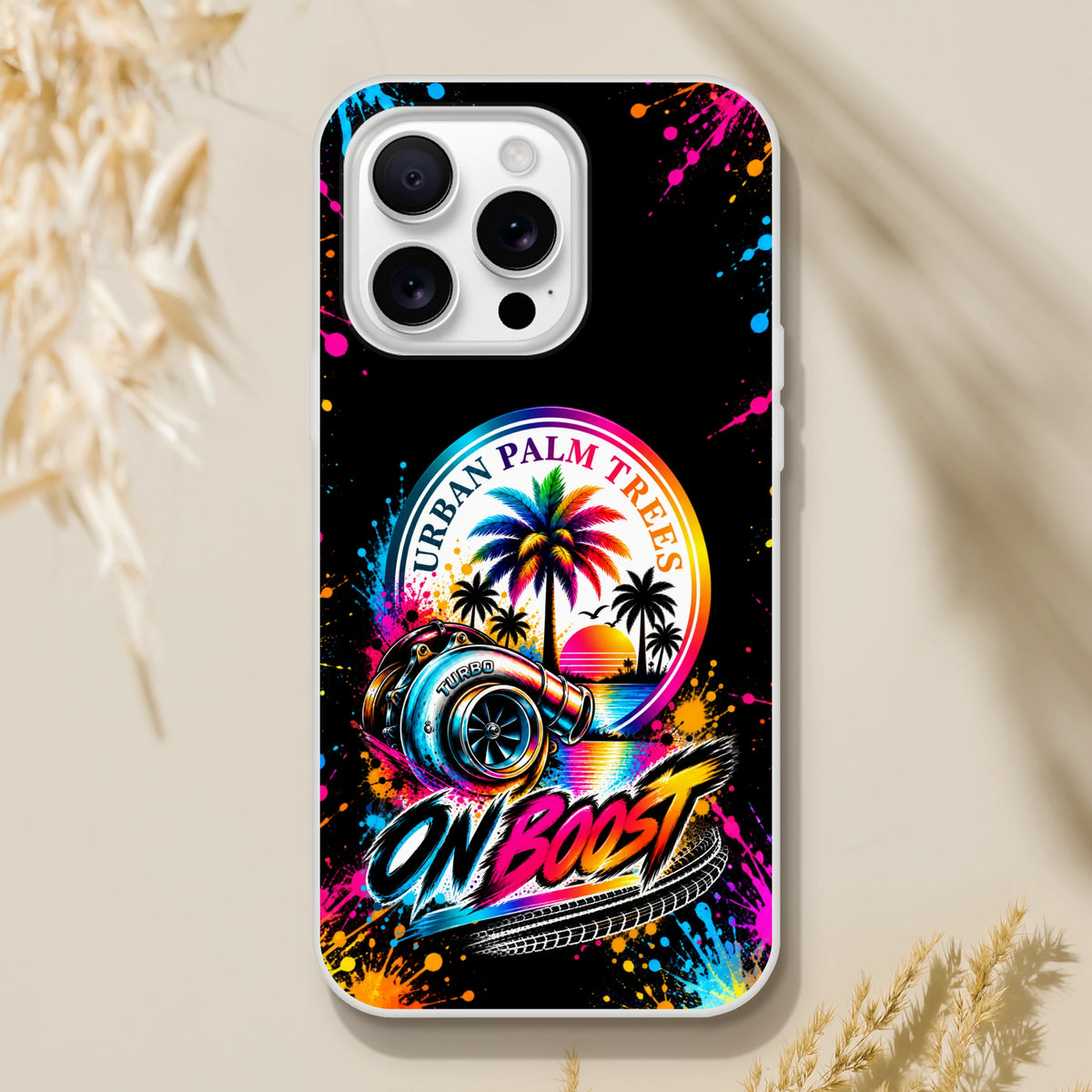 On Boost iPhone case featuring a colorful turbocharger, rainbow palm trees, and Urban Palm Trees text against a black splatter background.