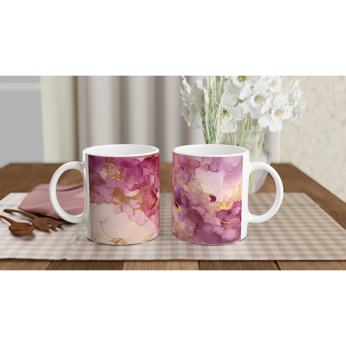 Two blush pink marble mugs with rose-gold abstract veining and white handles on a checkered placemat.