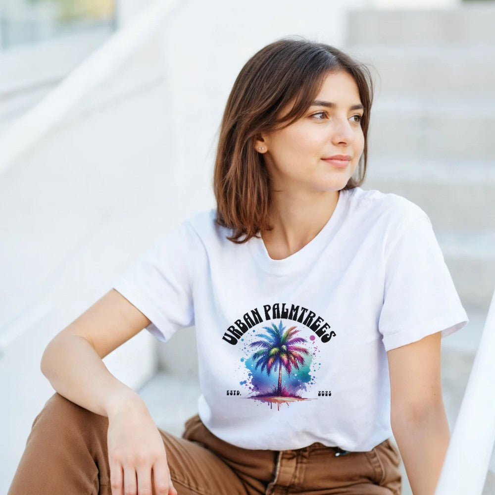 Woman wearing white Urban Palm Trees graphic tee, soft cotton-blend fabric, palm tree and colorful splash design.