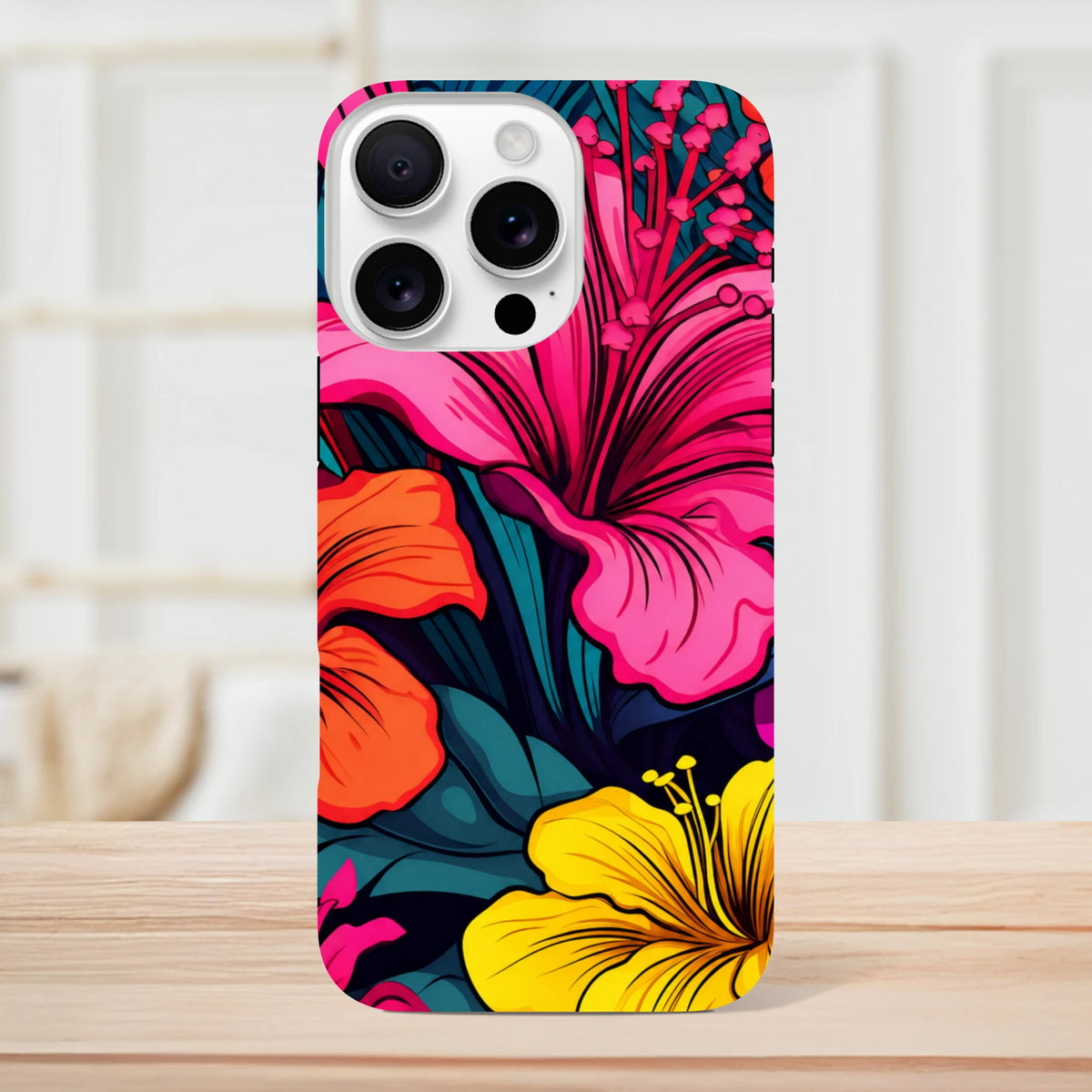 Vibrant pink, orange, and yellow hibiscus floral iPhone case with bold tropical leaves on a tough protective cover.