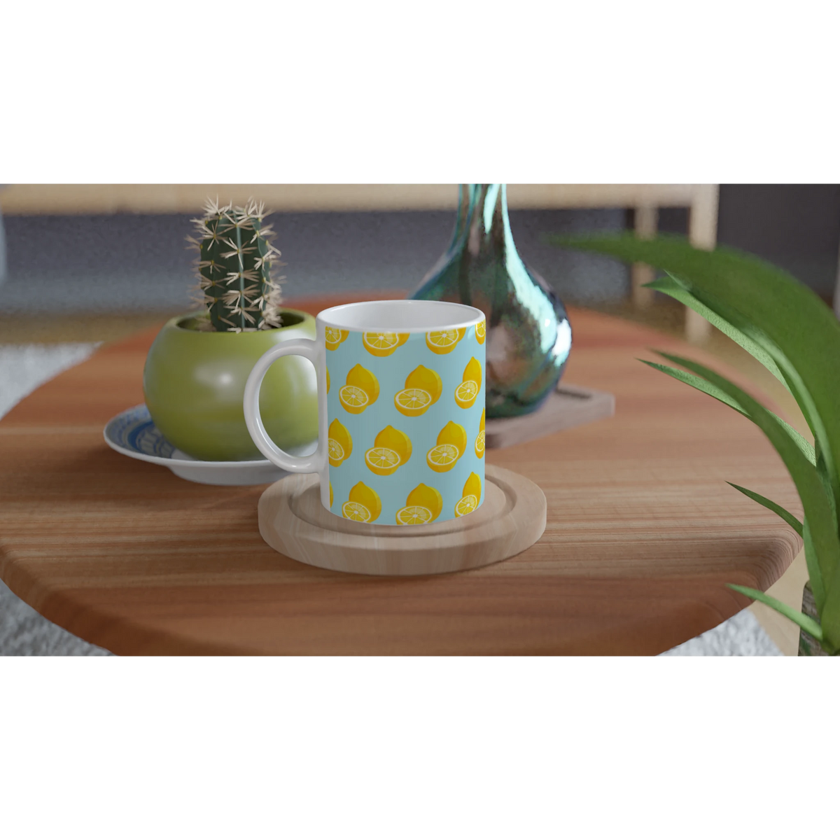 Pastel blue ceramic mug with yellow lemon pattern on wooden coaster next to a small cactus.