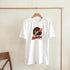White cotton-blend T-shirt featuring retro pop-art graphic of a woman with sunglasses and red lips, 'Retro Girl' logo.