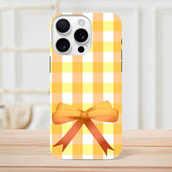Yellow gingham iPhone case with a 3D orange bow. Coquette plaid phone cover compatible with iPhone 13-16.