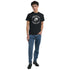 Model wearing black Motorcycle Club Graphic T-shirt with skull logo; cotton blend, crew neck, jeans and boots.