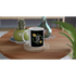 White ceramic mug with black label reading GOOD VIBES ONLY, surrounded by a green leafy wreath and yellow flowers.