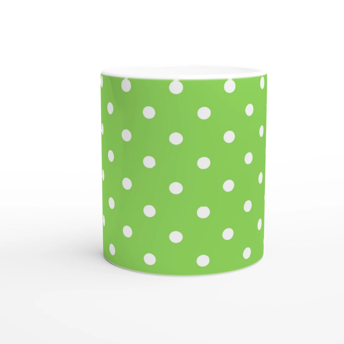 Vibrant green ceramic mug decorated with white polka dots. Spotty coffee cup design for daily coffee, tea, or gifting.