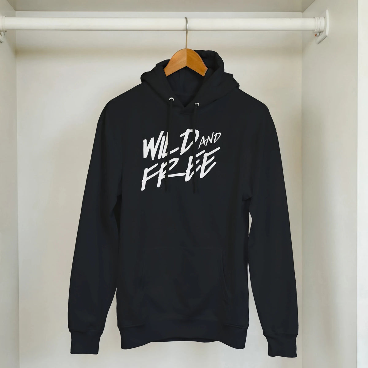 Cute Wild And Free Hoodie on hanger; black women's cozy slogan top with white script.