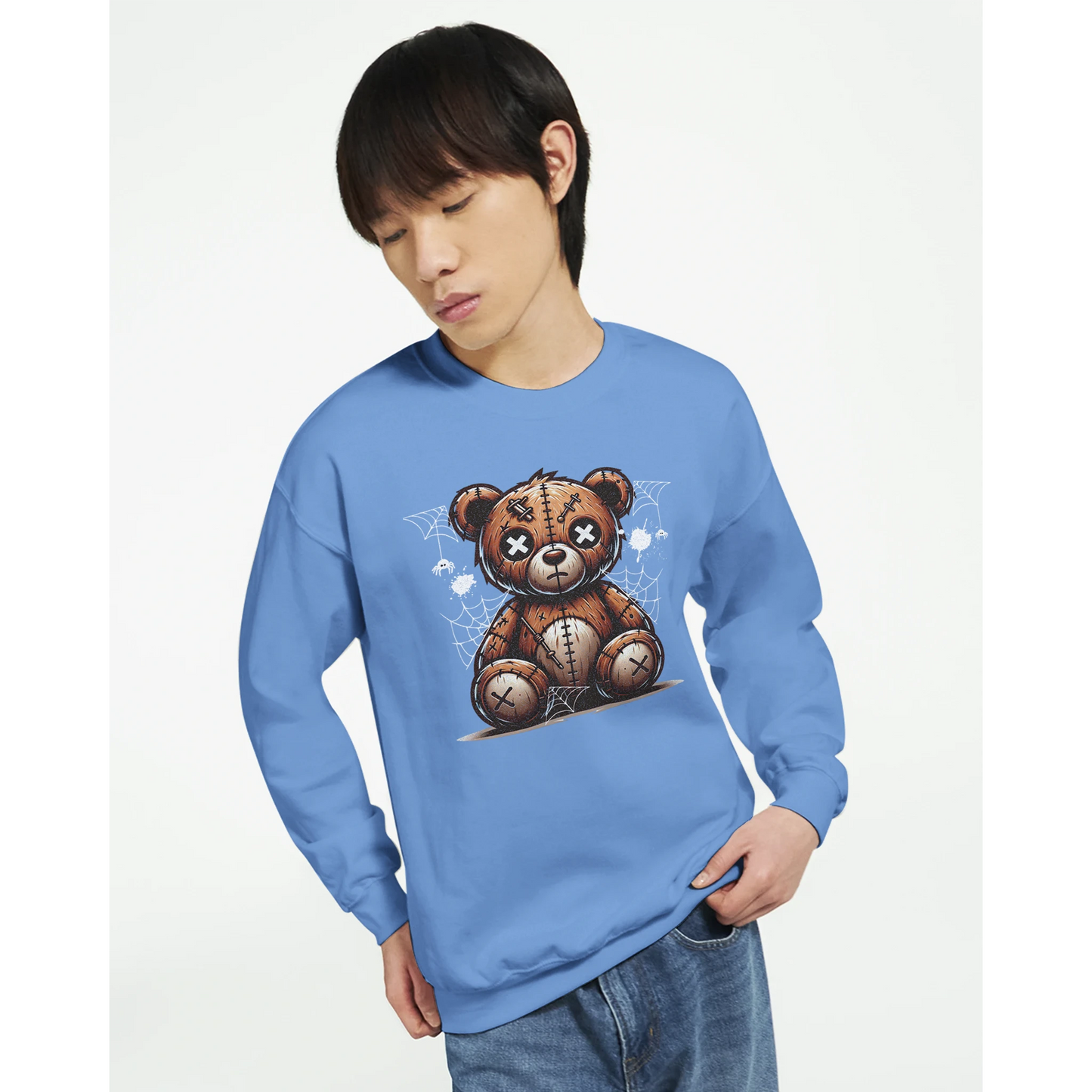 Person wearing a blue men's graphic sweatshirt with a teddy bear graphic on a white background