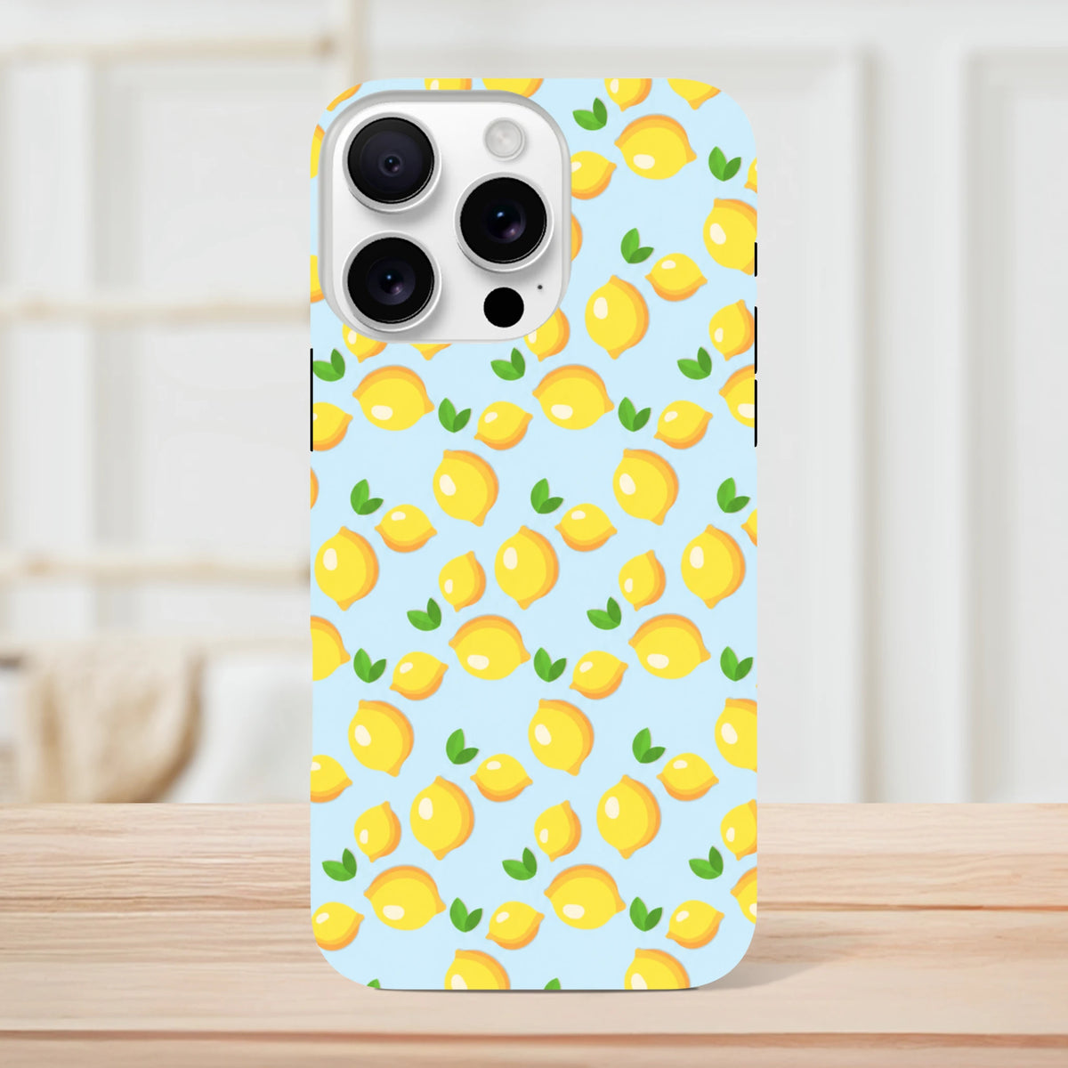 Cute lemon pattern iPhone case featuring fresh yellow fruit and green leaves on a light blue background for protective style.