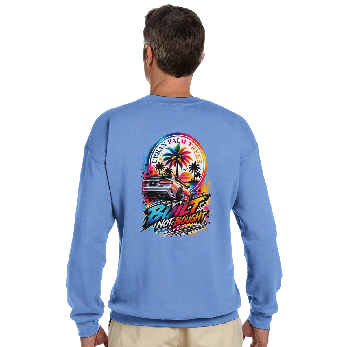 Blue sweatshirt back featuring colorful "Built Not Bought" graphic with modified car, palm trees, and Urban Palm Trees text.