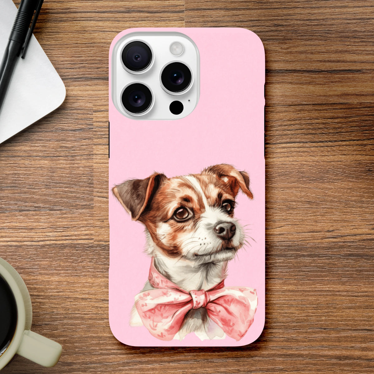Pink iPhone case featuring a cute brown and white dog wearing a floral pink bow tie on a soft pink background.
