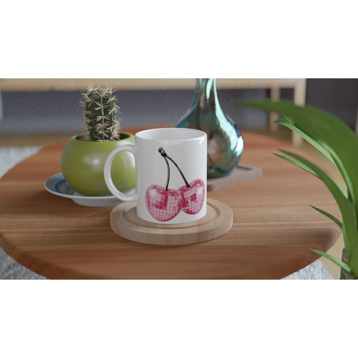 Cute Glitter Cherries retro aesthetic coffee cup on a wooden table, with cactus and vase nearby.