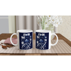 Pair of white ceramic mugs featuring navy It's OK Not To Be OK slogan, a thoughtful mental health gift.
