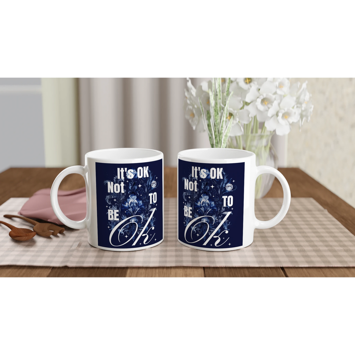 Pair of white ceramic mugs featuring navy It's OK Not To Be OK slogan, a thoughtful mental health gift.